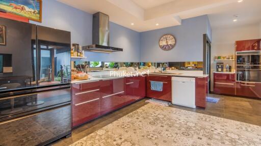 Modern kitchen with stainless steel appliances and red cabinets