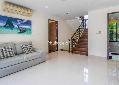 Modern living room with staircase and bathroom access