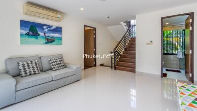 Modern living room with staircase and bathroom access