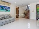 Modern living room with staircase and bathroom access