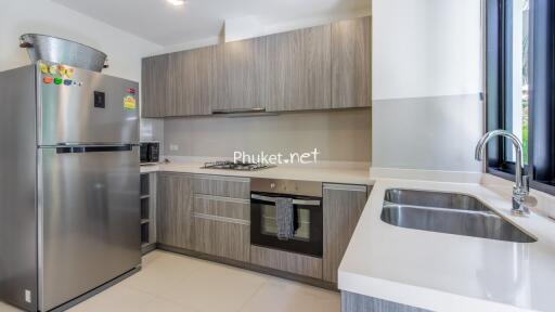 Modern kitchen with stainless steel appliances and wooden cabinets