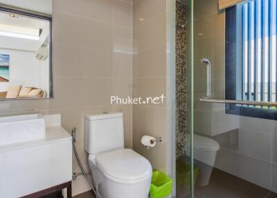 Modern bathroom with glass shower and white fixtures