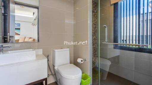 Modern bathroom with glass shower and white fixtures