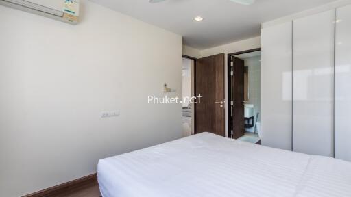 Bedroom with white walls and bed