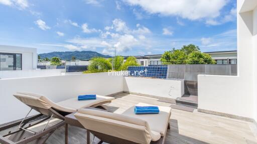 Outdoor patio with lounge chairs and a scenic view