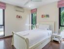 Bright bedroom with white bed, pink curtains, and large windows