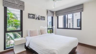 Modern bedroom with large windows and a double bed