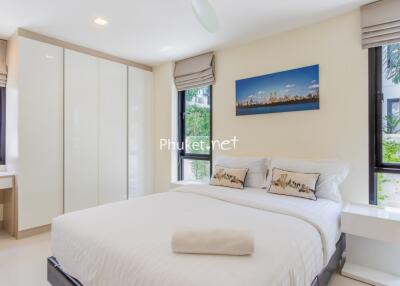 Modern bedroom with large windows and a double bed