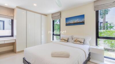 Modern bedroom with large windows and a double bed