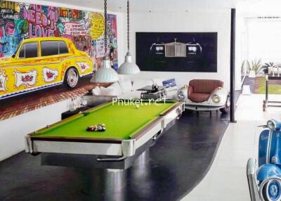 Fun entertainment area with pool table and vibrant car-themed decor