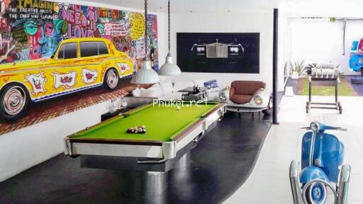 Fun entertainment area with pool table and vibrant car-themed decor