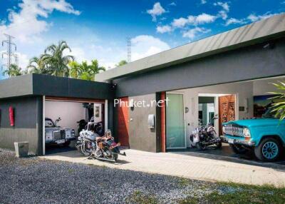 Modern house with garage and vintage vehicles