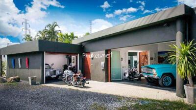 Modern house with garage and vintage vehicles