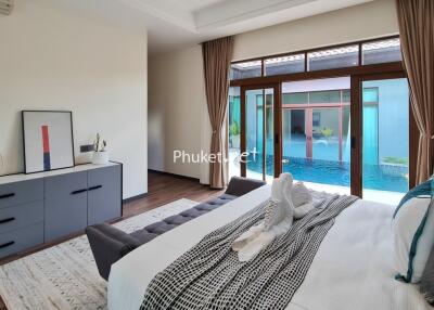 Modern bedroom with pool view and decorative elements