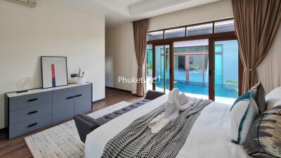 Modern bedroom with pool view and decorative elements