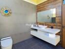 Modern bathroom with wall-mounted sink and wooden accents