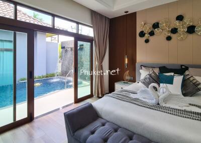 Spacious bedroom with pool view and modern decor