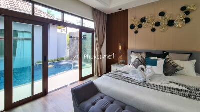 Spacious bedroom with pool view and modern decor