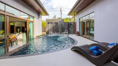 Modern outdoor area with pool and lounge chairs