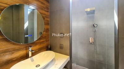 Modern bathroom with wooden accents and a stylish shower