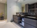 Modern bathroom with dual sinks and storage