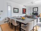 Modern dining room with table set for six, adjacent to a living area with artwork and plants