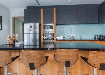 Modern kitchen with wooden chairs and appliances