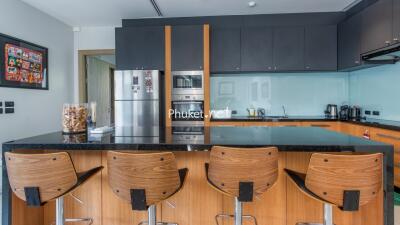 Modern kitchen with wooden chairs and appliances