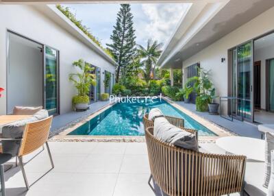 Modern outdoor space with swimming pool and seating area