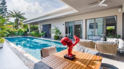 Modern outdoor living area with pool and patio furniture