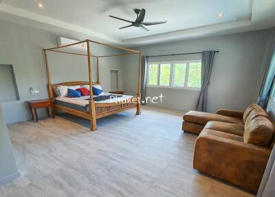 Spacious bedroom with a canopy bed and sitting area
