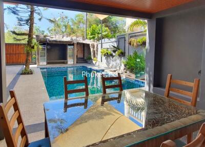 Patio with view of swimming pool