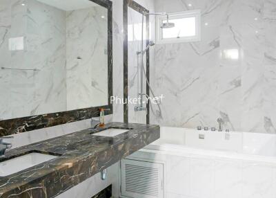Modern bathroom with marble countertops and bathtub