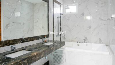 Modern bathroom with marble countertops and bathtub