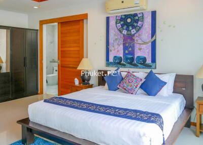 Spacious and well-decorated bedroom with a comfortable bed and modern amenities