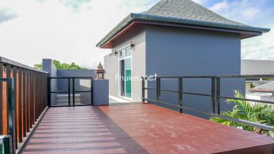 Spacious rooftop terrace with modern railings and a view