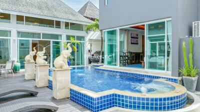 Outdoor area with swimming pool and decorative elephant fountains