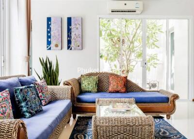 Bright living room with wicker furniture and colorful cushions