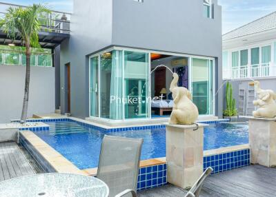 Modern outdoor area with a swimming pool and sculptures