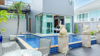 Modern outdoor area with a swimming pool and sculptures