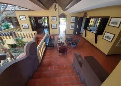 Spacious living area with tiled floor and indoor plants