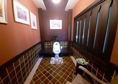 Cozy bathroom with modern toilet and decorative accents