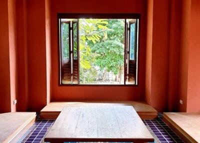 Spacious living room with vibrant tiles and large window