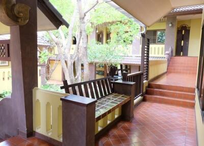 Outdoor corridor with seating area and tree view