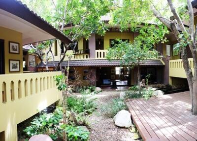 Exterior view of a two-story house with greenery