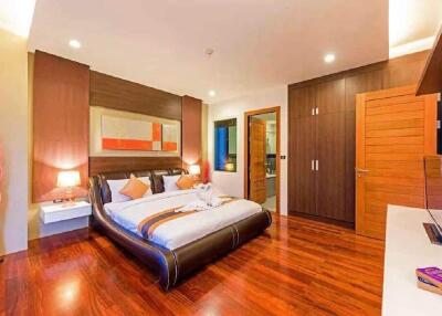 Modern bedroom with double bed, wooden flooring, and contemporary decor