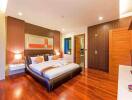 Modern bedroom with double bed, wooden flooring, and contemporary decor