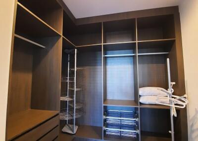 Spacious walk-in closet with built-in shelves and lighting