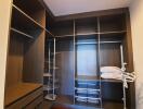 Spacious walk-in closet with built-in shelves and lighting