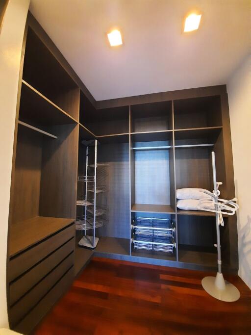 Spacious walk-in closet with built-in shelves and lighting